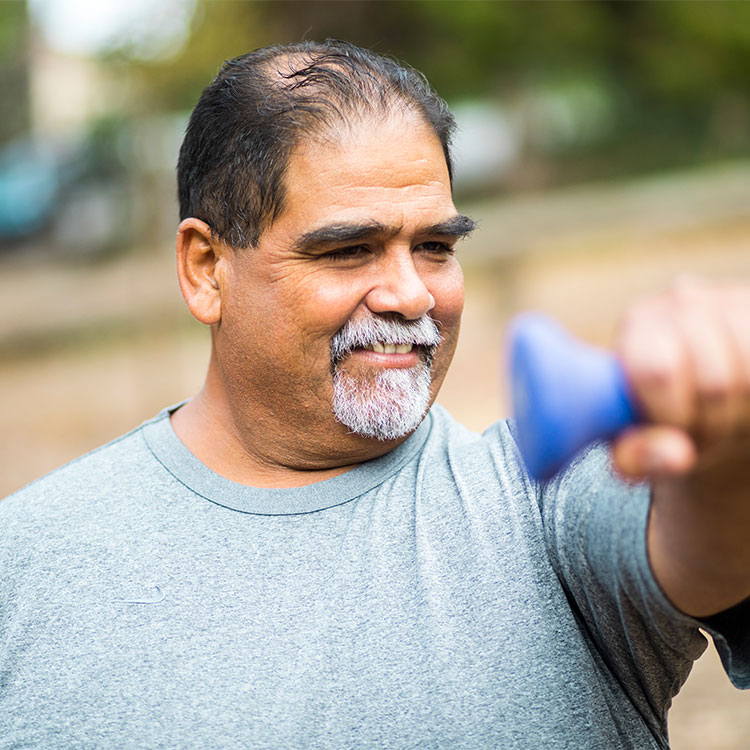 Older out-of-shape Latino man exercising